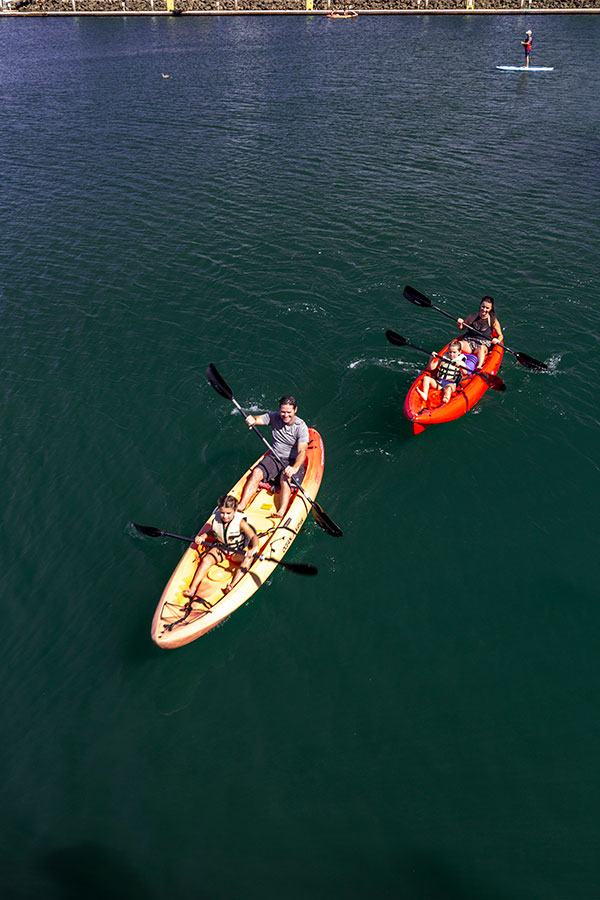 family of four kayaking in two separate kayaks