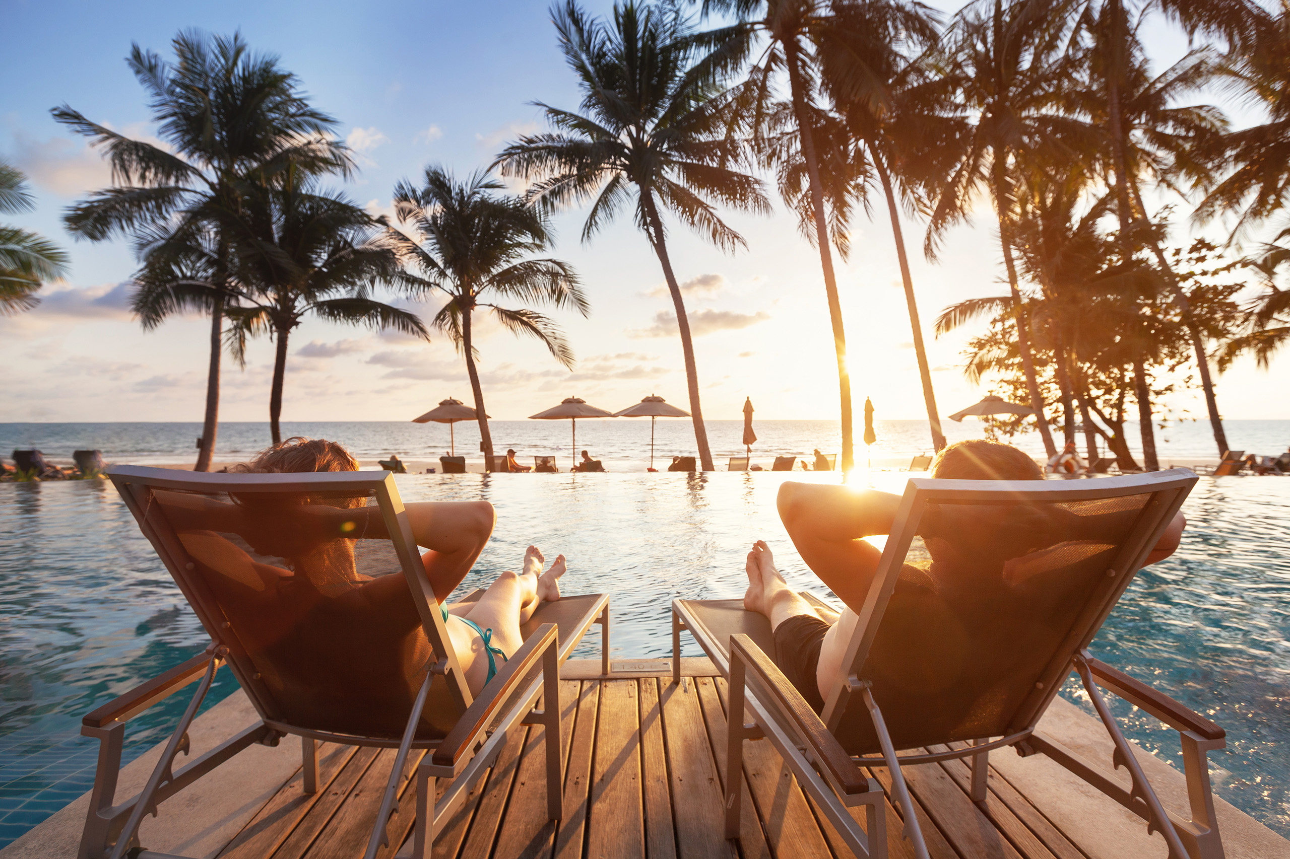 couple enjoying sunset in Caribbean at beach front luxury hotel
